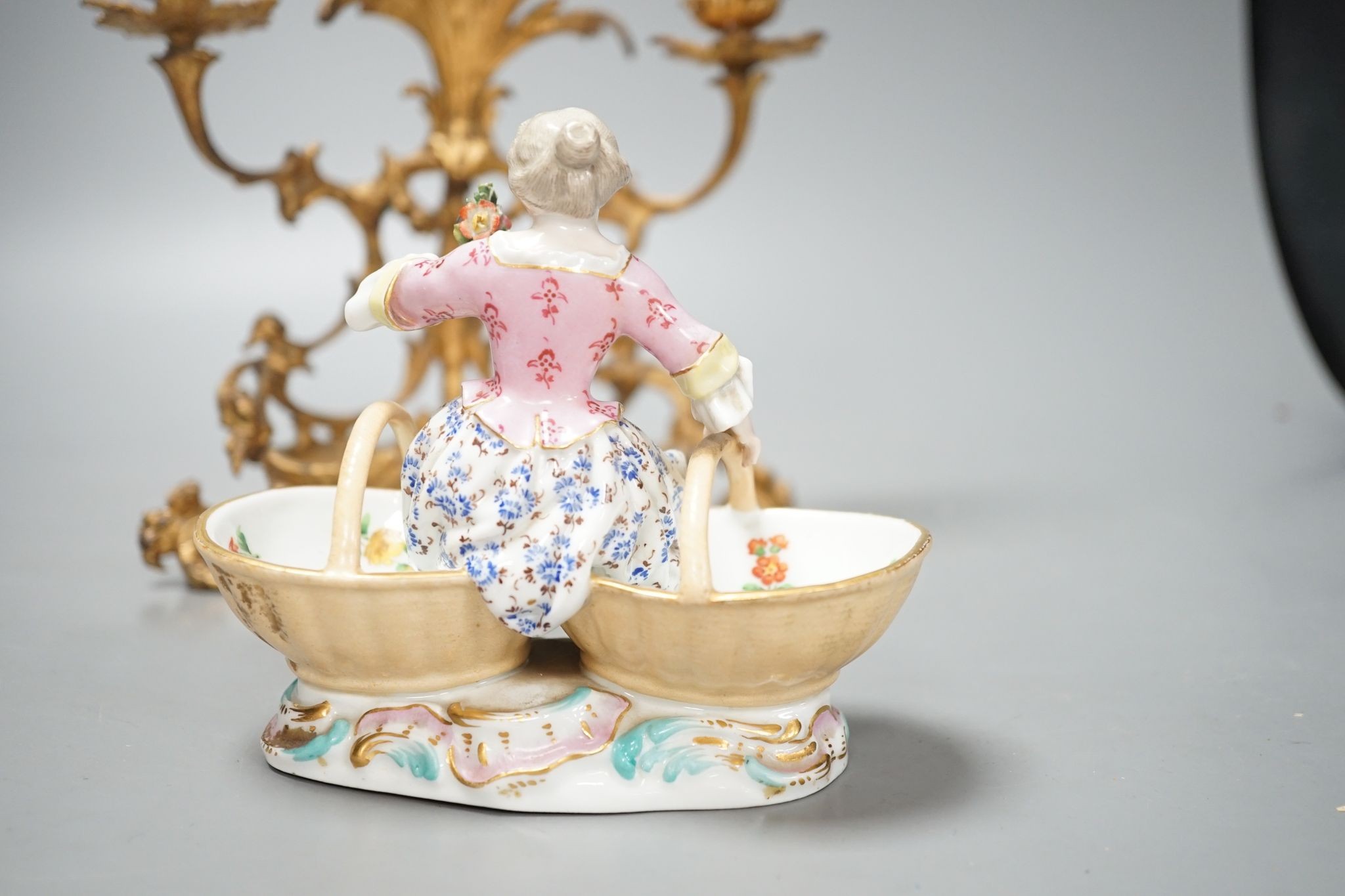 A 19th century Meissen figural salt, incised number 3024, on ormolu candle stand. Total height - 21cm